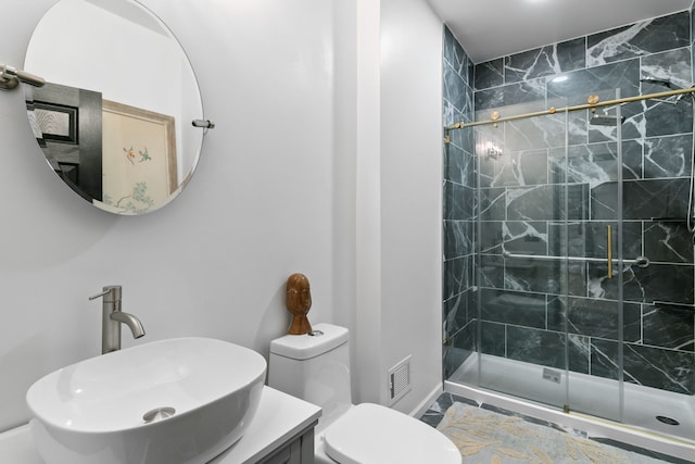 bathroom featuring vanity, an enclosed shower, and toilet