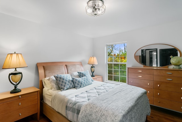 bedroom with dark wood-type flooring