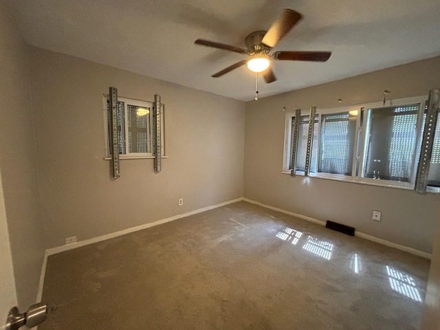 carpeted spare room featuring ceiling fan