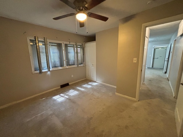 unfurnished bedroom with light carpet and ceiling fan