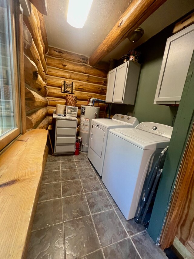 laundry room featuring rustic walls, cabinets, gas water heater, washing machine and dryer, and a textured ceiling