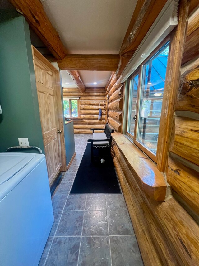 game room with beam ceiling, log walls, and washer / dryer