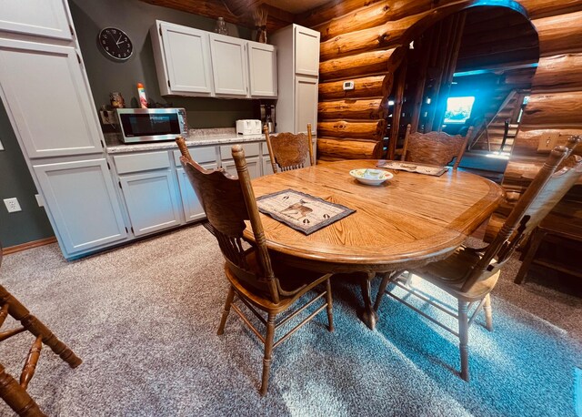 dining area featuring log walls