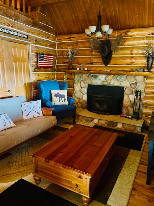 living room featuring log walls, hardwood / wood-style flooring, vaulted ceiling, and a fireplace