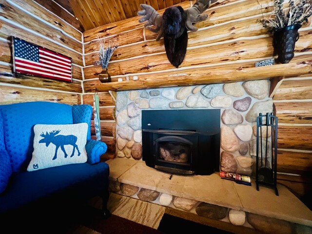 interior details featuring a wood stove and rustic walls