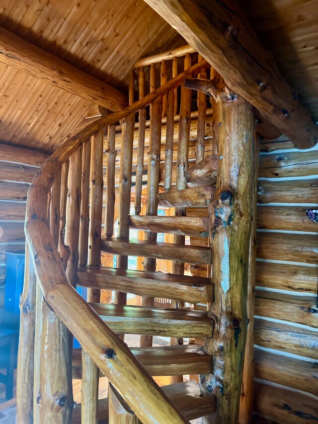 stairway featuring beam ceiling and wood ceiling