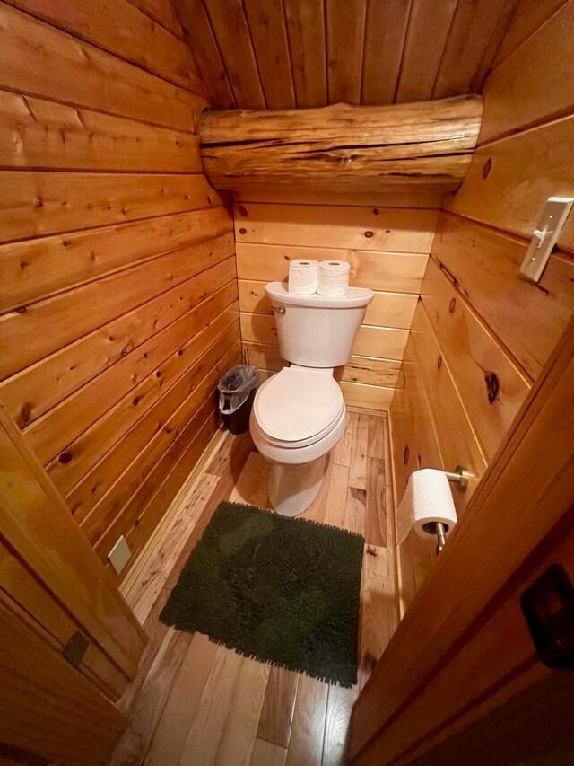 bathroom featuring hardwood / wood-style flooring, toilet, wood ceiling, and wood walls