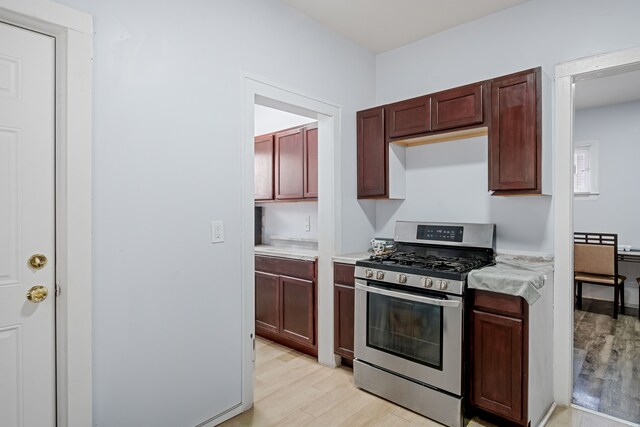5015 Vancouver St, Detroit, MI 48204 - kitchen with stainless steel gas stove, light countertops, and light wood-style floors