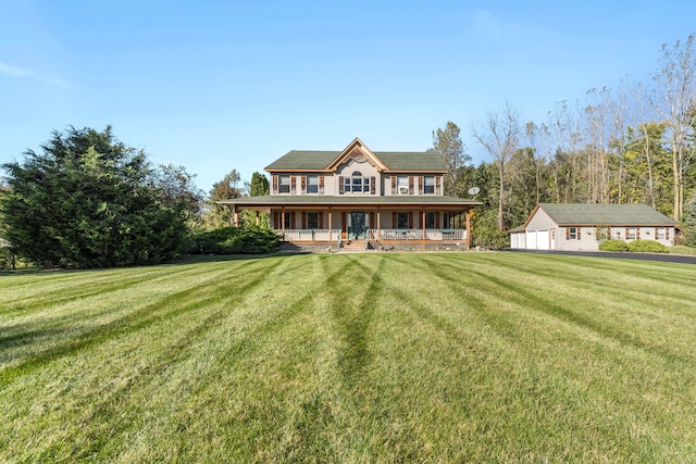 view of front of home featuring an outbuilding, a front yard, a porch, and a garage