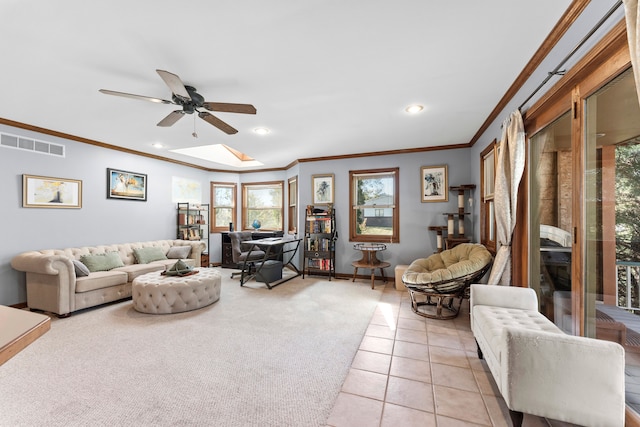 tiled living room featuring ceiling fan, crown molding, and a skylight