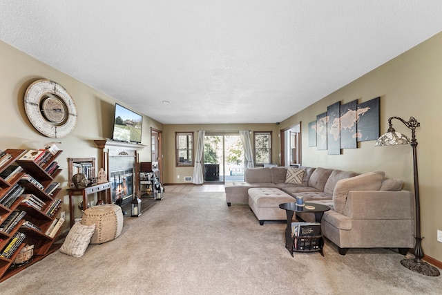 living room featuring a textured ceiling and light colored carpet