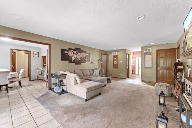 living room with light tile patterned flooring and a textured ceiling