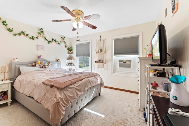 carpeted bedroom featuring ceiling fan and cooling unit