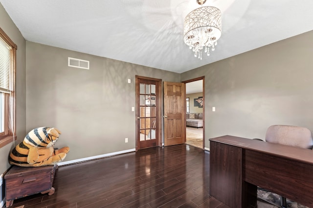 office area with dark hardwood / wood-style flooring and an inviting chandelier