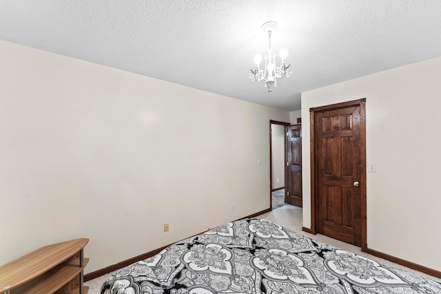 bedroom featuring a textured ceiling and a notable chandelier