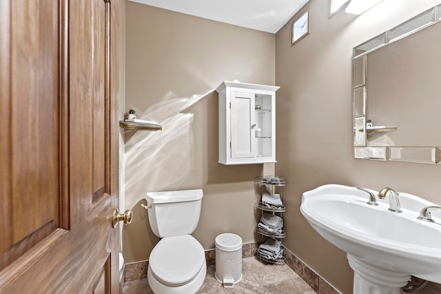 bathroom with tile patterned flooring, toilet, and sink