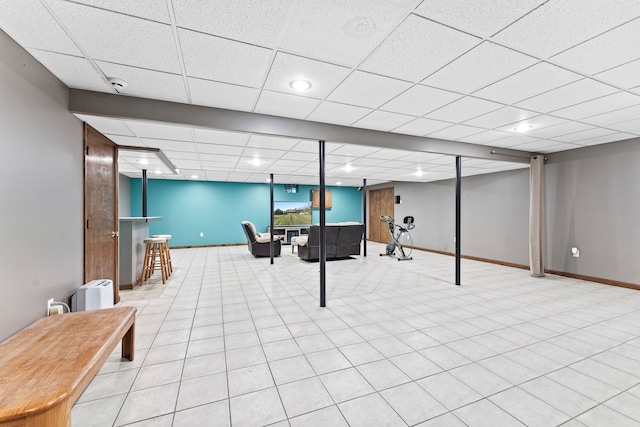 playroom with a drop ceiling and light tile patterned flooring