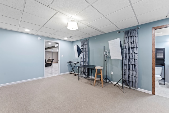 miscellaneous room featuring a drop ceiling and light colored carpet