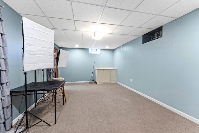 interior space featuring carpet and a drop ceiling