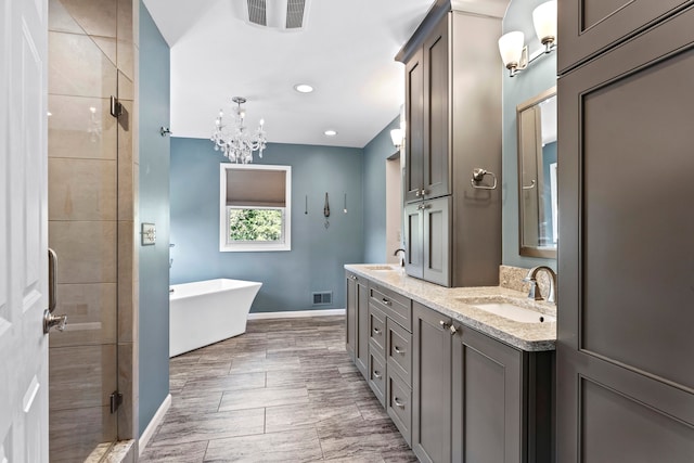 bathroom featuring vanity, independent shower and bath, and a chandelier