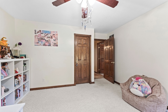 interior space with ceiling fan and carpet floors