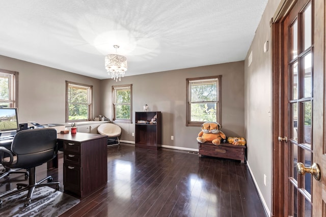 home office with a chandelier, a textured ceiling, and dark hardwood / wood-style flooring