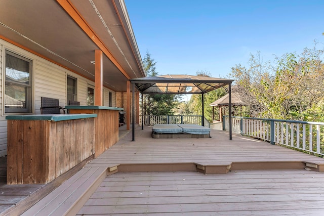 deck with a gazebo and a covered hot tub