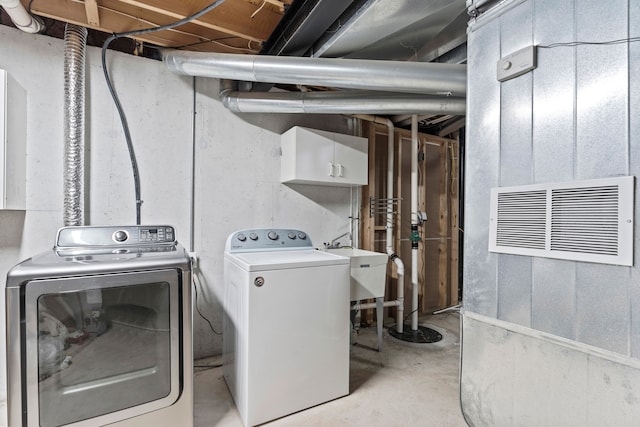 washroom featuring washer and clothes dryer, cabinets, and sink