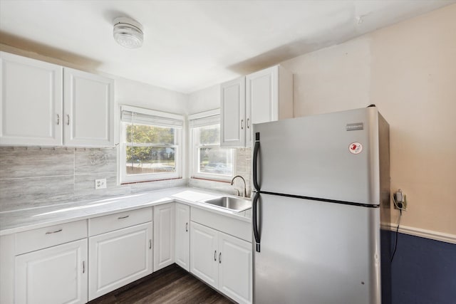 kitchen with white cabinetry, stainless steel refrigerator, dark hardwood / wood-style floors, and sink