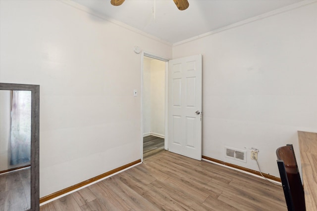 unfurnished room featuring ceiling fan, wood-type flooring, and ornamental molding