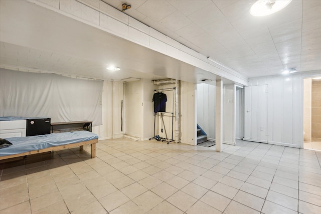 basement featuring light tile patterned flooring