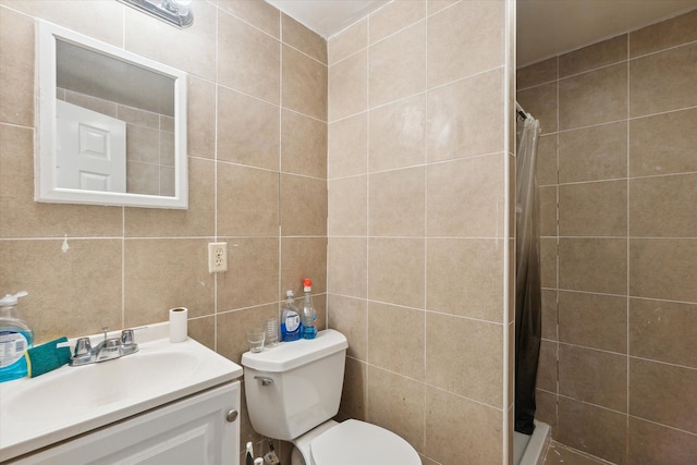 bathroom with a shower with shower curtain, vanity, toilet, and tile walls