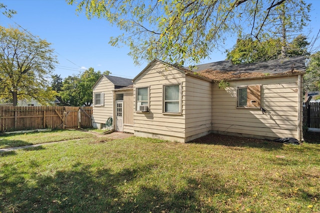 rear view of property with a yard