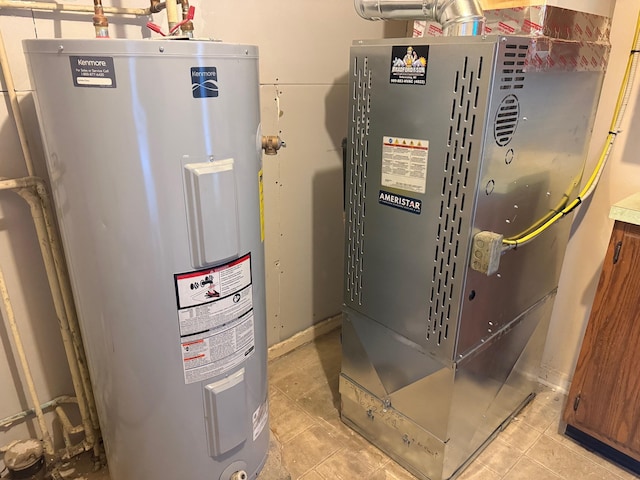 utility room featuring heating unit and electric water heater