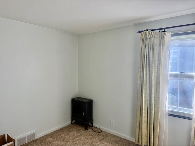 carpeted empty room with baseboards and visible vents