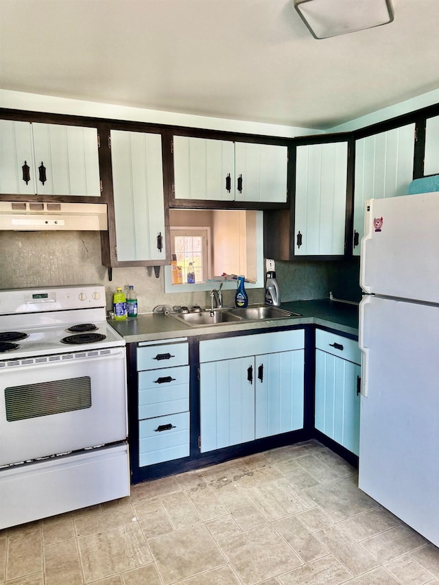 kitchen featuring under cabinet range hood, white appliances, and a sink