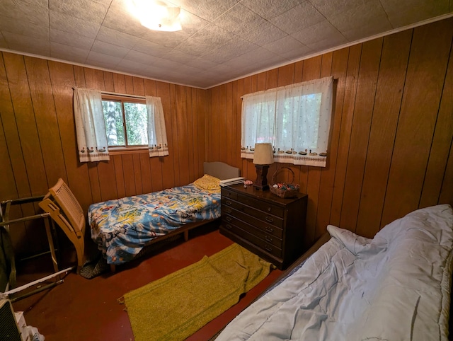 bedroom featuring wooden walls