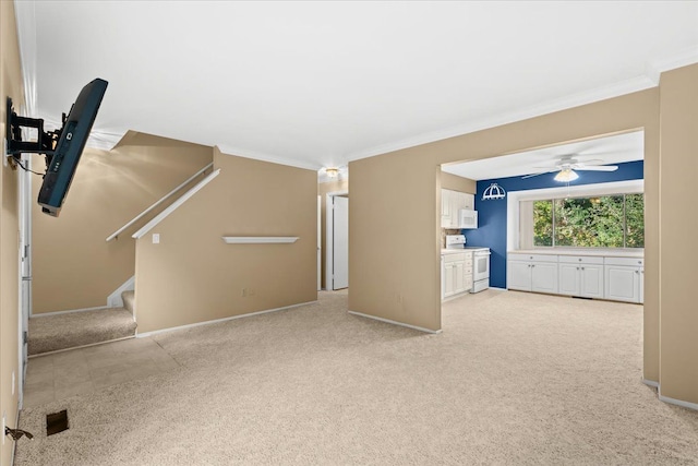 unfurnished living room featuring ceiling fan, crown molding, and light carpet