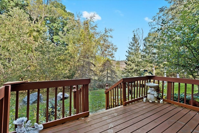 wooden deck featuring a yard