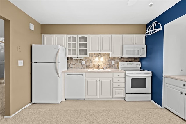 kitchen with white cabinets, white appliances, backsplash, and sink