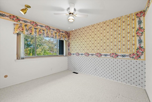 spare room featuring carpet flooring and ceiling fan