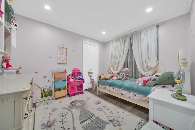 bedroom featuring crown molding and light hardwood / wood-style floors