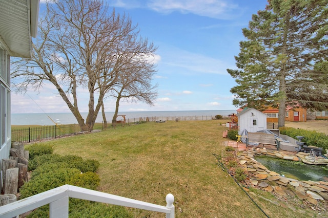 view of yard with a water view and a shed