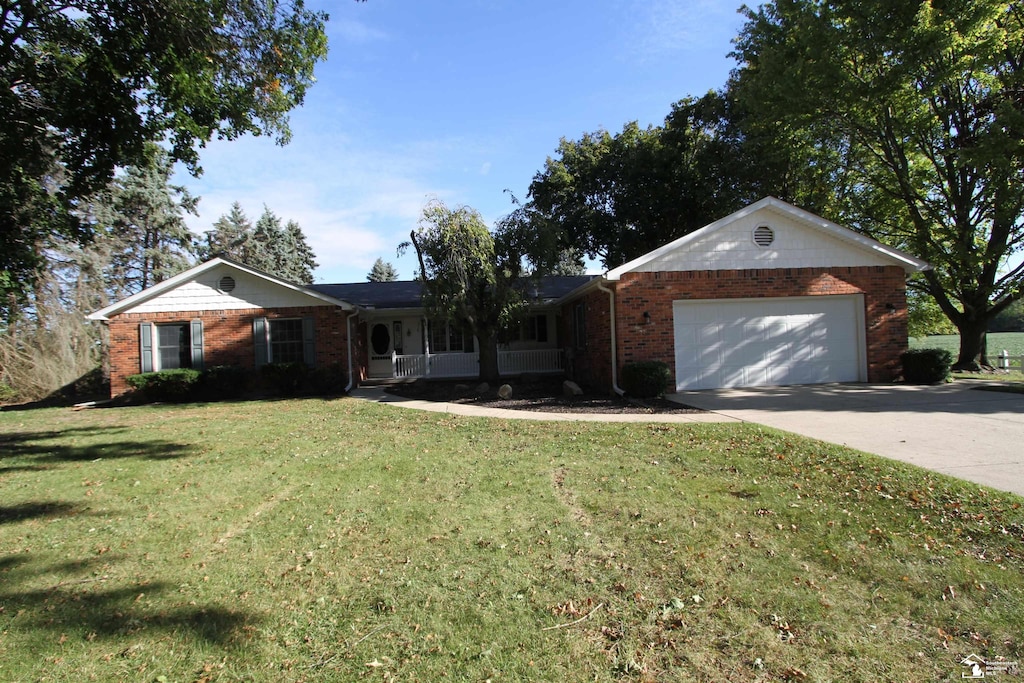 ranch-style home with a garage and a front yard