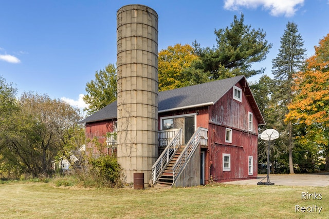 back of property featuring a lawn