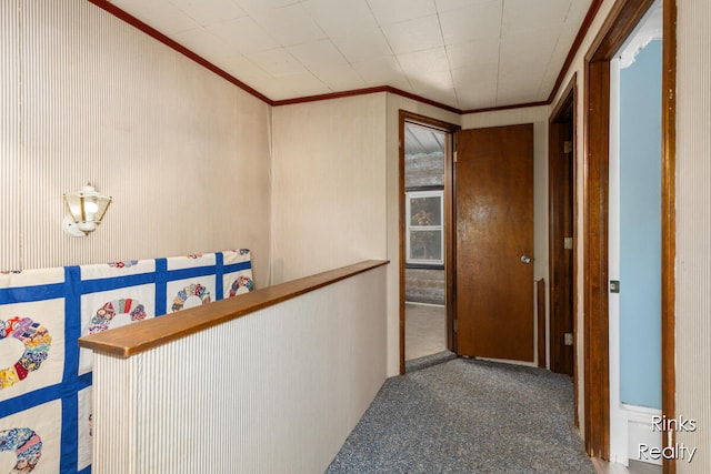 corridor with carpet and crown molding