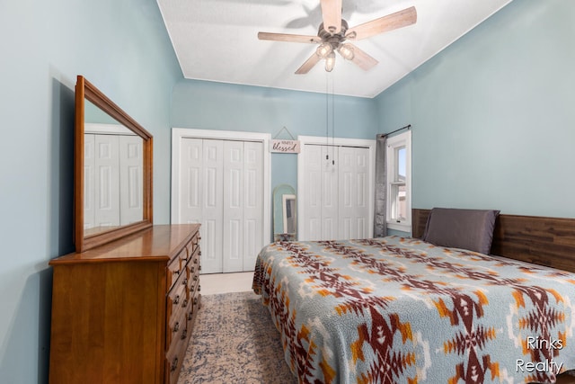 bedroom with ceiling fan and multiple closets