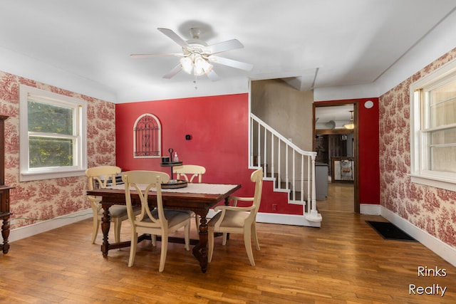 dining space with hardwood / wood-style flooring and ceiling fan