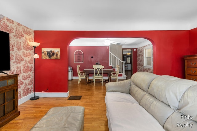 living room featuring hardwood / wood-style flooring and ceiling fan