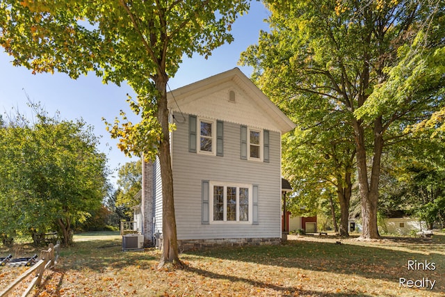 view of home's exterior featuring a lawn and central air condition unit